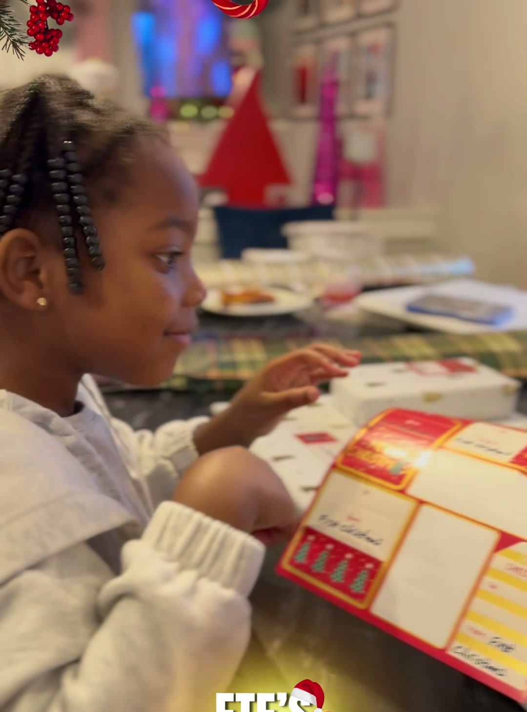 A child from our first family smiling as she opens her First Christmas gift